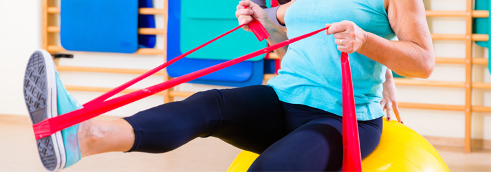Chiropractic Lincoln NE DNS A patient using a theraband for rehab exercises