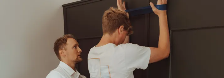 Chiropractor Lincoln NE Tanner Mazour Theraputic Exercise Tanner Mazour helping a patinet with their theraputic exersices